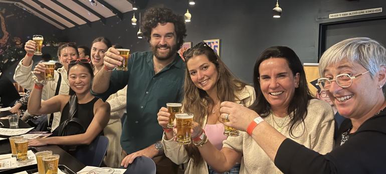 Event attendees raise a glass together