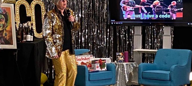 Executive Director Sharon Olken singing karaoke after her $1,000 fundraising challenge was met