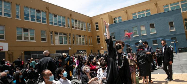 graduate throws cap in the air