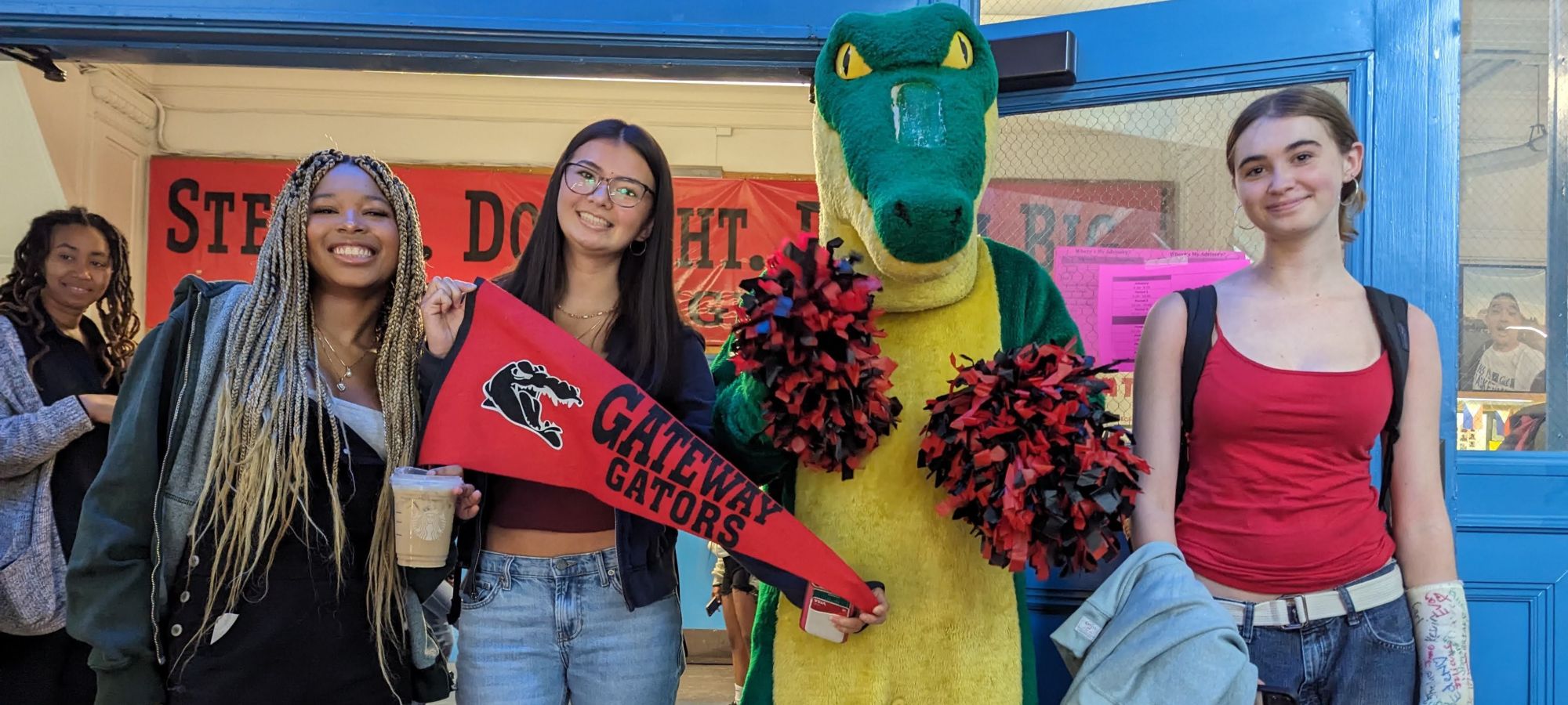 students pose with gator masco