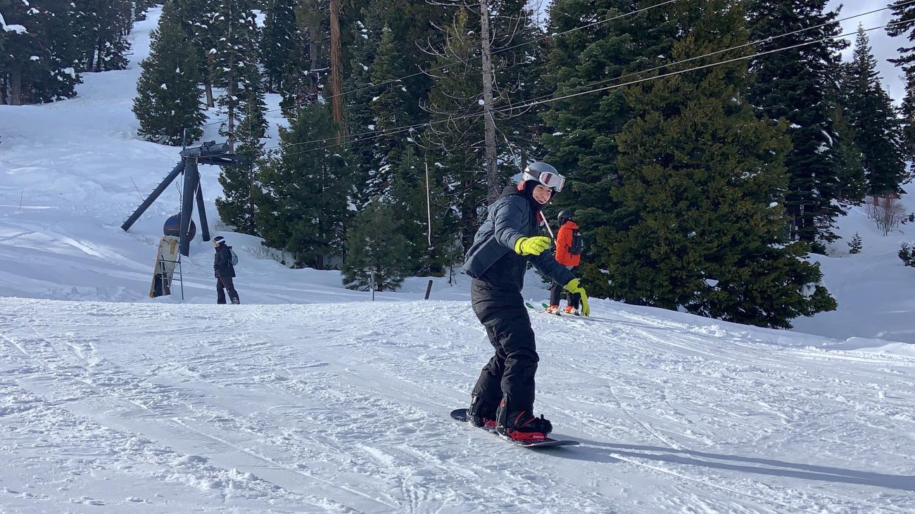 student snowboarding